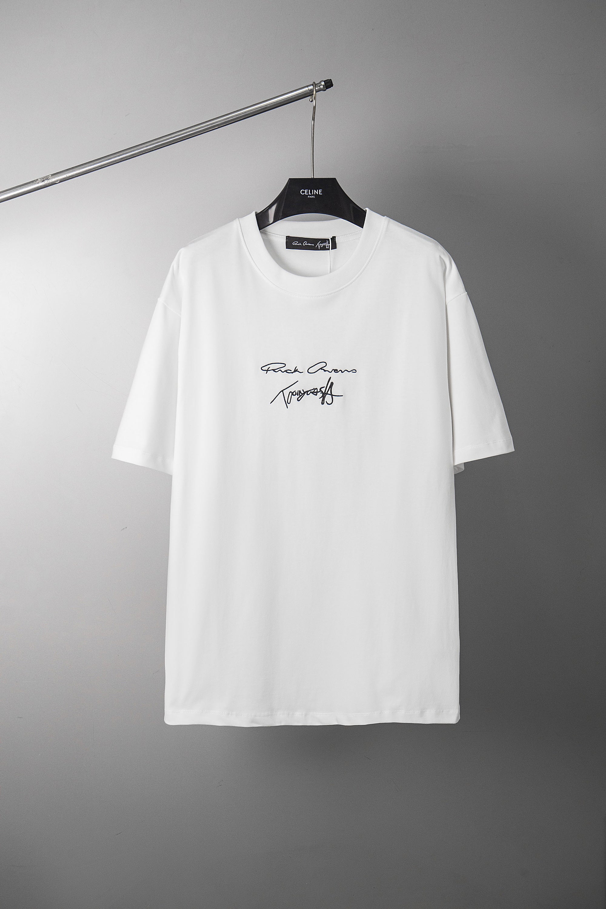 White crewneck T-shirt with small script logo graphic at chest