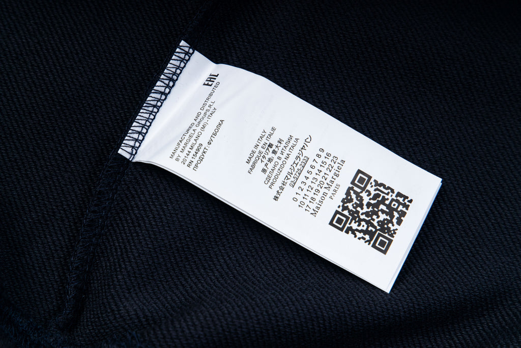 Dark fabric care label with printed size and QR code