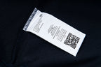 Dark fabric care label with printed size and QR code