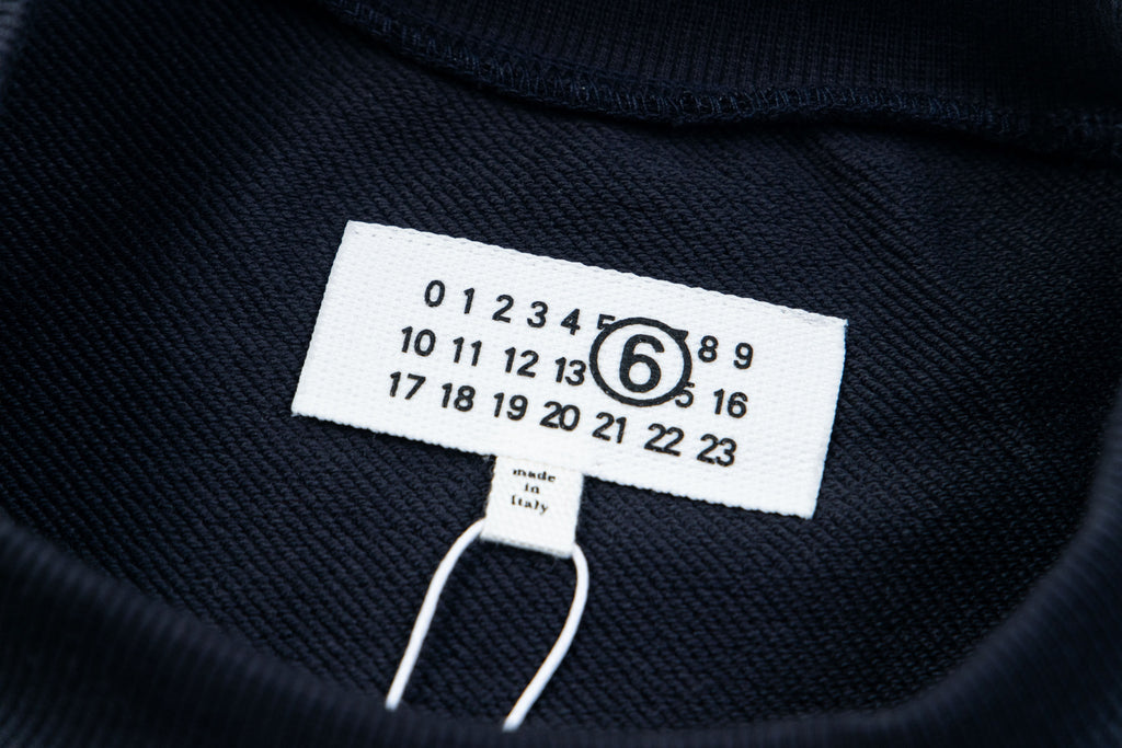 Dark sweatshirt neckline tag with size and care text