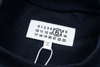 Dark sweatshirt neckline tag with size and care text