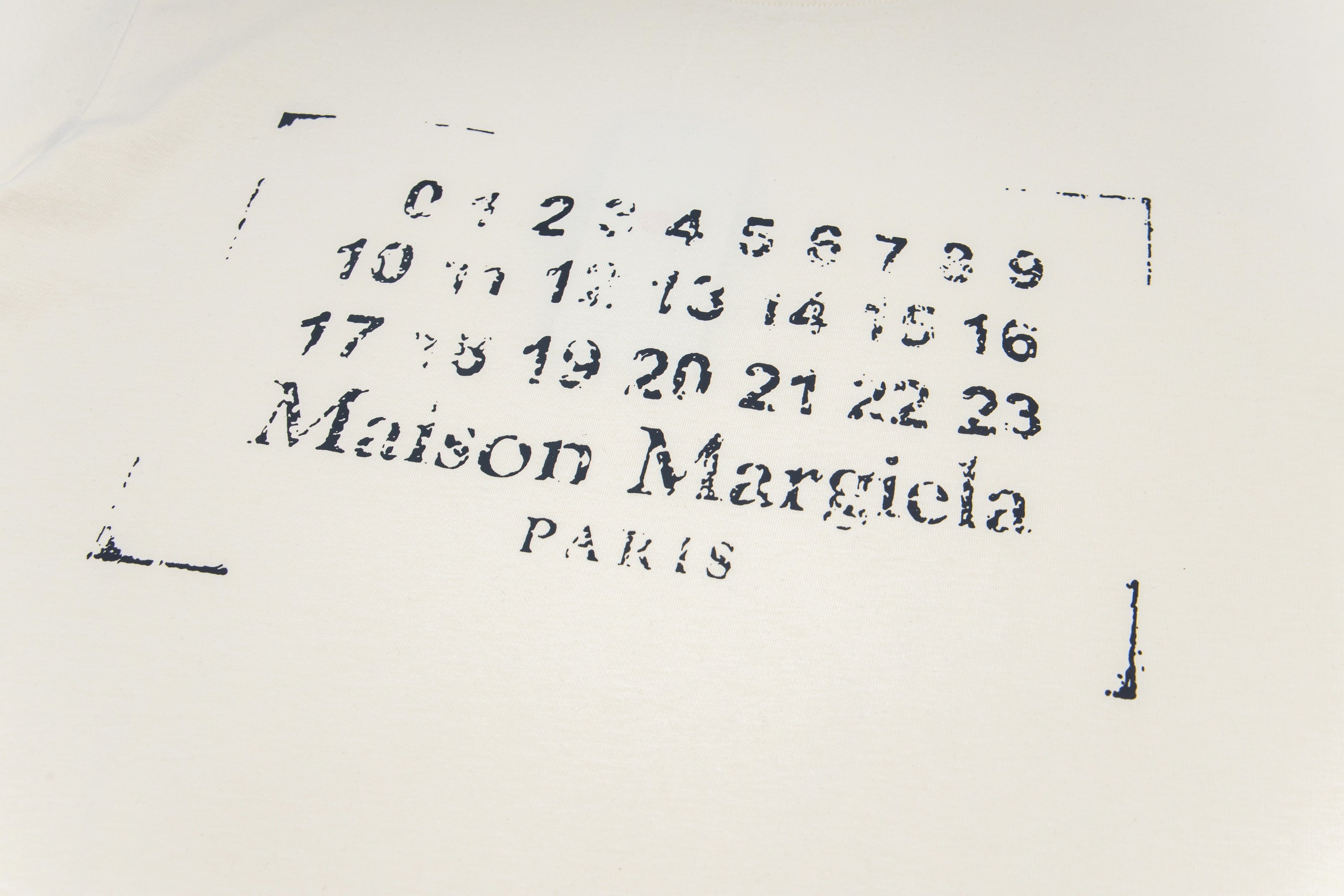 Cream T-shirt close-up of number graphic and “Maison Margiela PARIS”