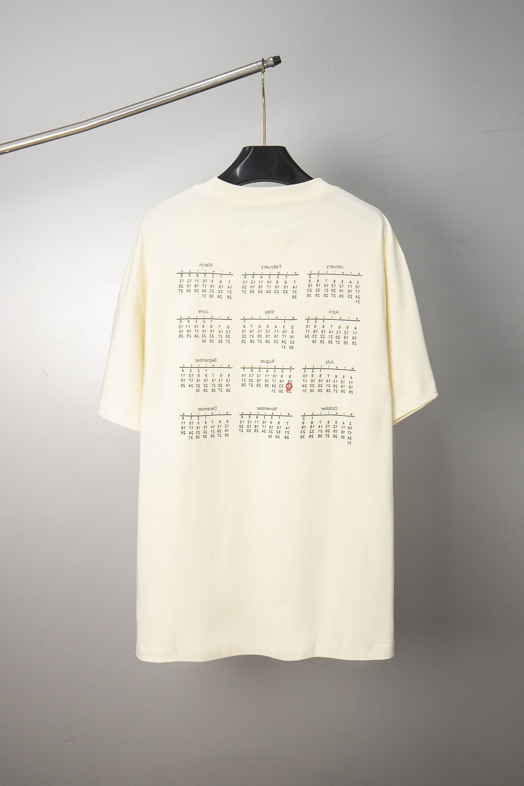 Cream crew-neck T-shirt back with grid-style text graphic