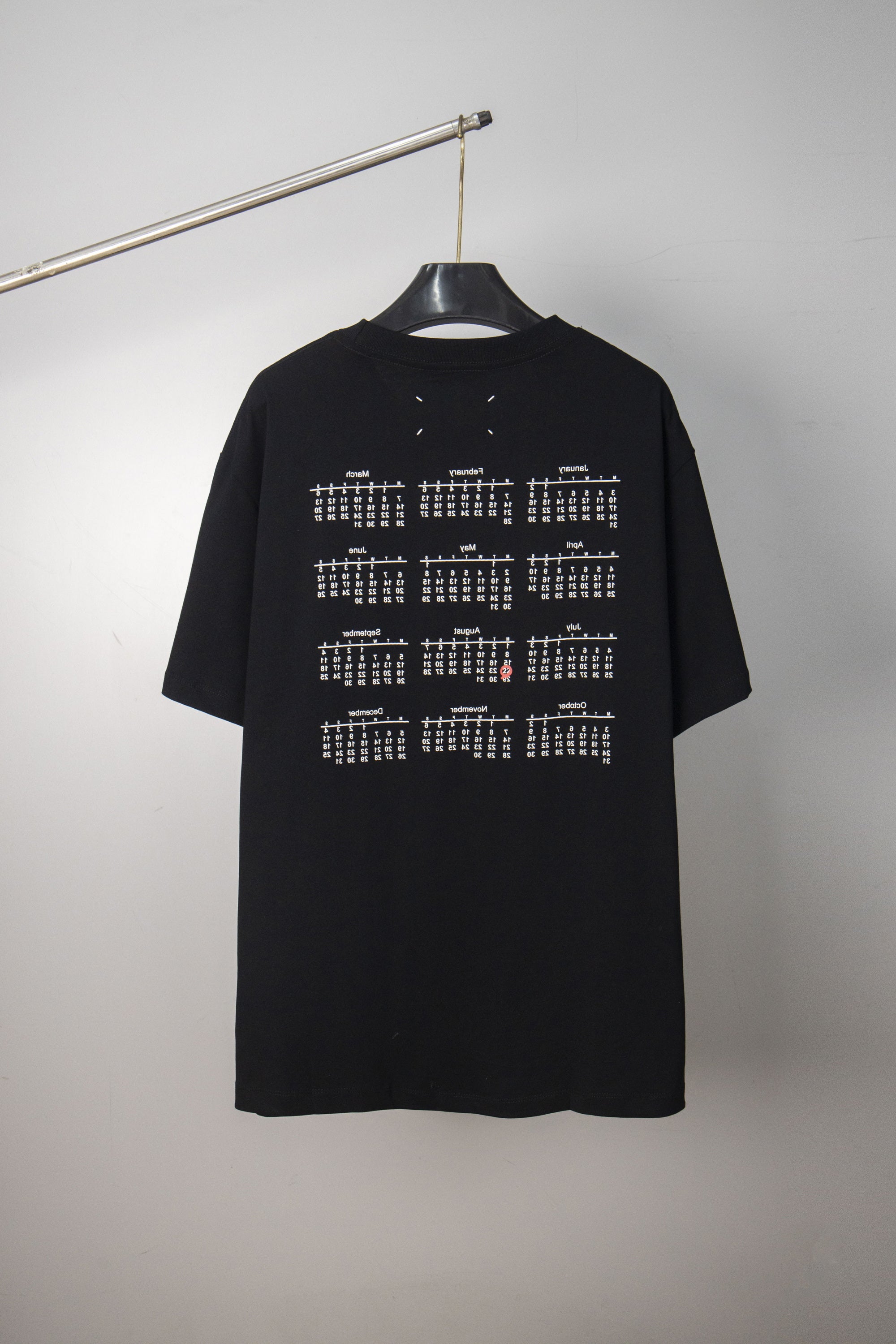 Black crew-neck T-shirt back with grid-style text graphic