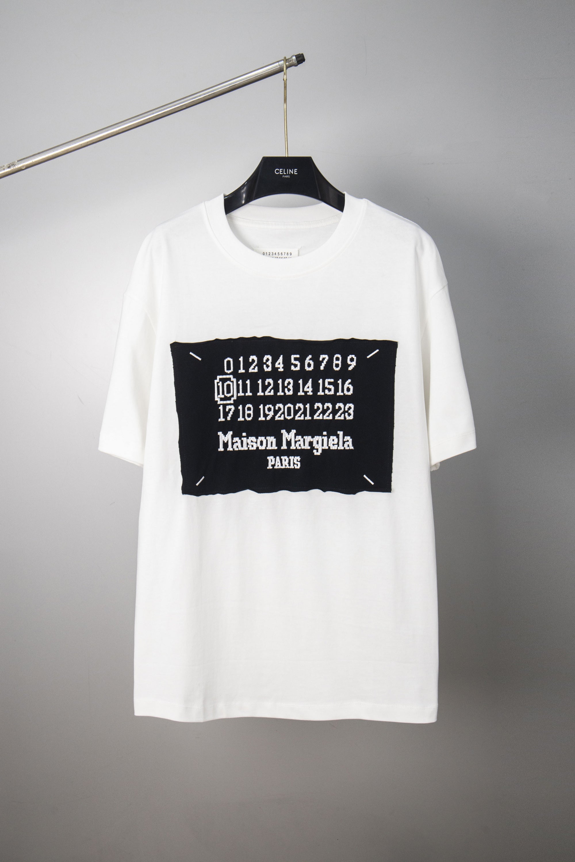White crewneck T-shirt with black Maison Margiela number graphic on chest