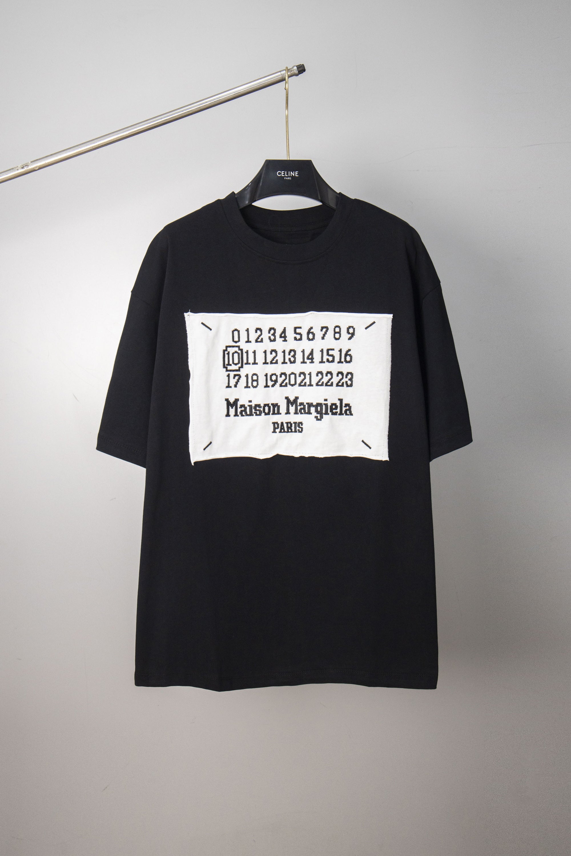 Black crewneck T-shirt with white Maison Margiela number graphic on chest
