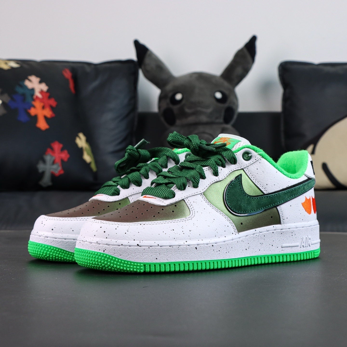 Air Force 1 sneakers, white upper with green swoosh and olive overlays; green outsole.