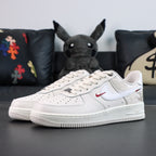 White Air Force 1 low sneakers with red swoosh and patterned upper