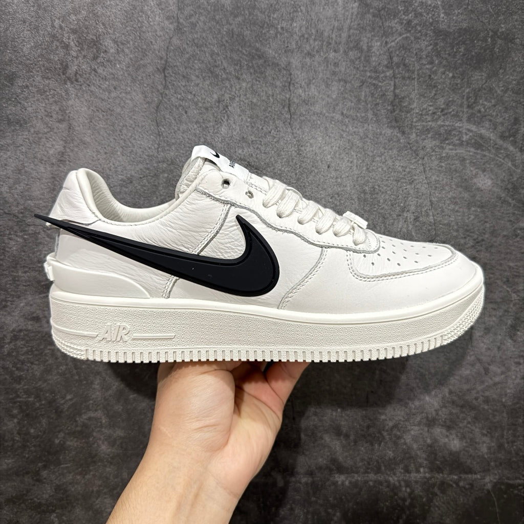White leather low-top sneaker with black swoosh and AIR detail on side