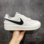 White leather low-top sneaker with black swoosh and AIR detail on side