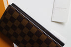 Louis Vuitton checkered wallet top edge with dark trim and brown monogram pattern