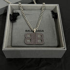Rhinestone BB pendant necklace on gray pouch with chain and black bow accents