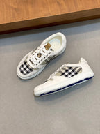 Burberry sneakers with white leather, black check quarters, and blue-tinted sole