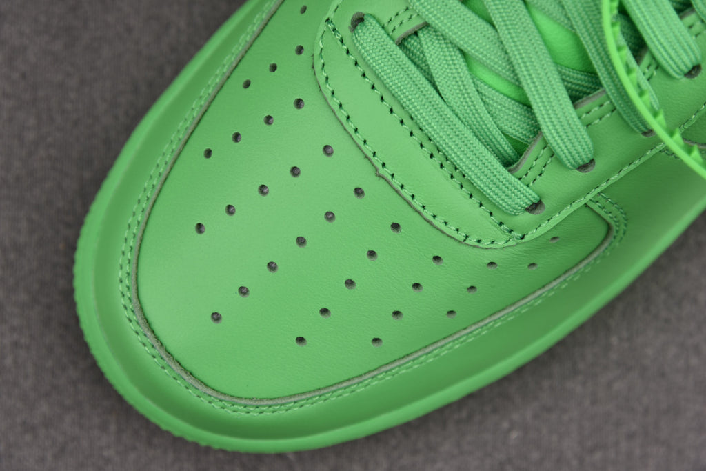 Green leather toe box with perforations and curved white outsole edge