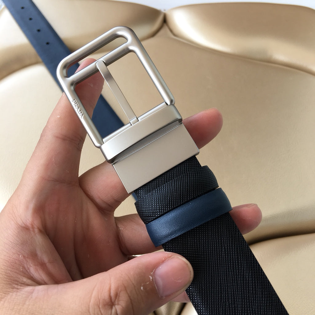 Dark blue belt with silver rectangular buckle and leather keeper