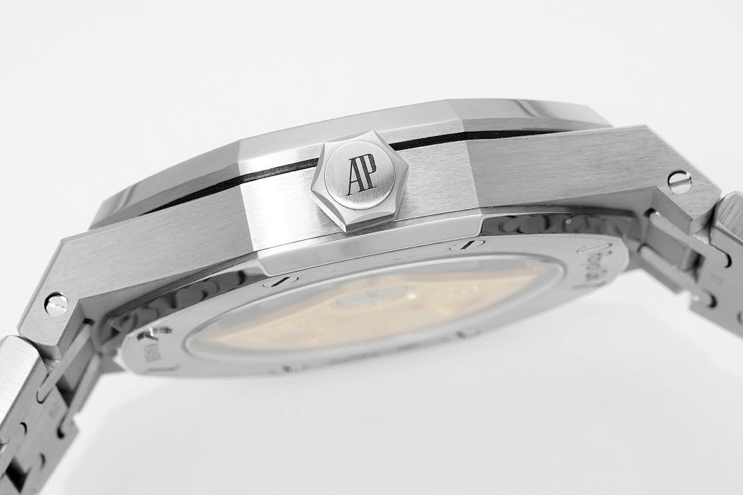 Audemars Piguet Royal Oak watch case top with AP emblem and brushed steel link sections.