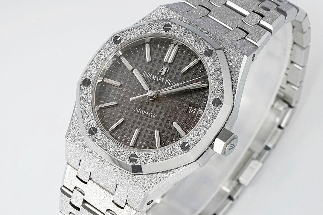 Audemars Piguet Royal Oak watch close-up with black textured dial, silver bezel, and bracelet links.