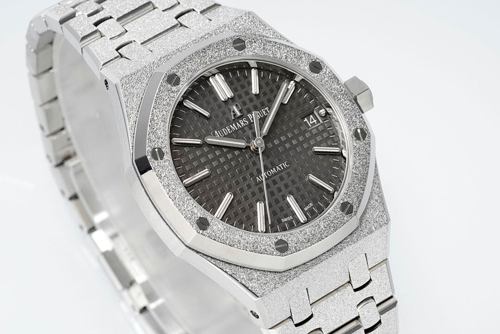 Audemars Piguet Royal Oak watch angled close-up with black dial, silver octagonal bezel, steel band.