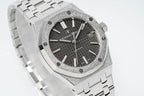 Audemars Piguet Royal Oak watch angled close-up with black dial, silver octagonal bezel, steel band.