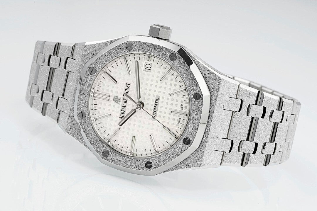 Audemars Piguet steel watch with white dial, baton hands, and link bracelet