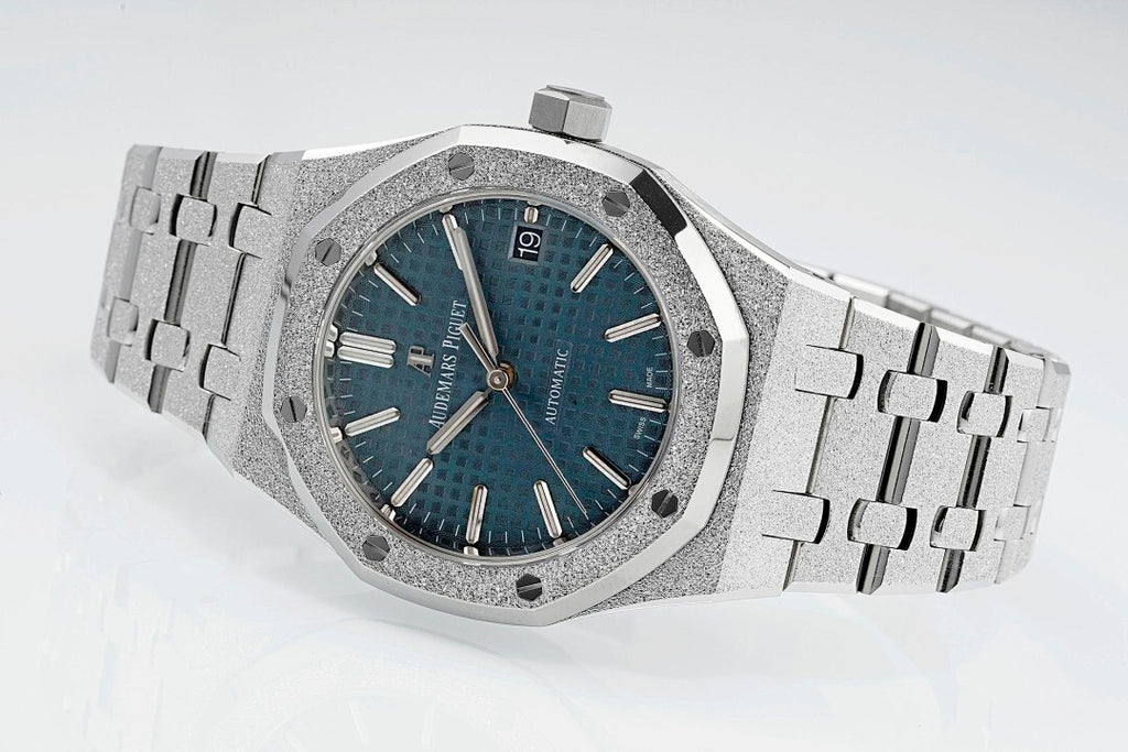 Audemars Piguet watch with textured blue dial, silver links, and crown at 3 o'clock