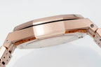 Rose gold-toned watch case back with brushed metal finish and crown side