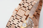 Rose gold-toned metal link bracelet with square engraved center links