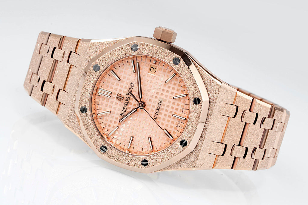 Audemars Piguet rose gold-tone watch with textured bezel and light peach dial