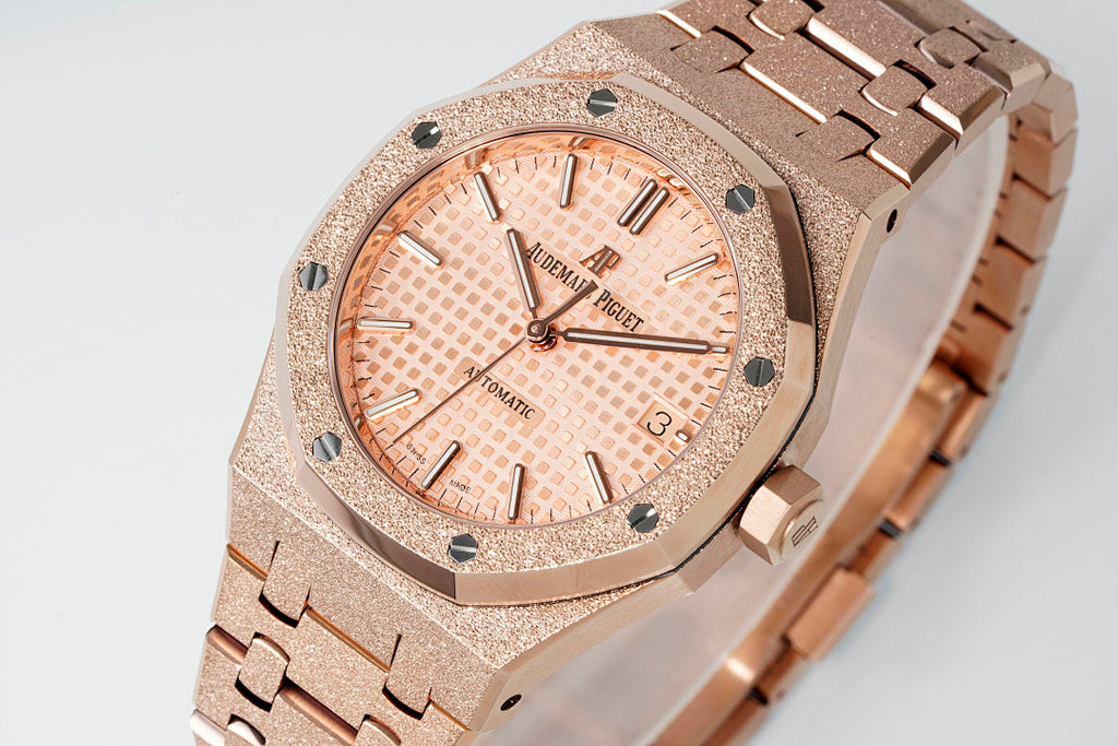 Audemars Piguet rose gold-tone watch with textured bezel and peach grid dial