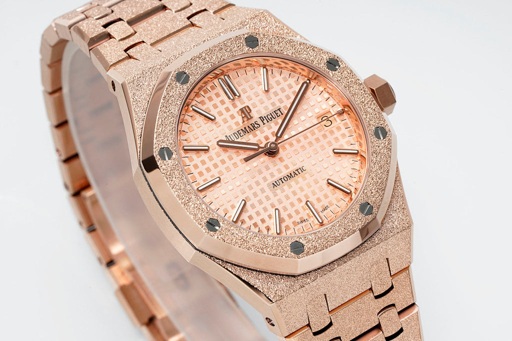 Audemars Piguet rose gold-tone watch close-up with peach dial and metal bracelet