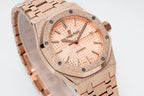 Audemars Piguet rose gold-tone watch close-up with peach dial and metal bracelet