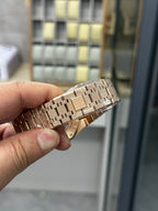 Audemars Piguet watch rose gold metal bracelet links and case edge, close-up