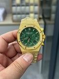 Audemars Piguet watch with gold case and green dial, three chronograph subdials, bracelet