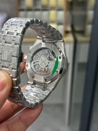 Audemars Piguet watch caseback with exposed mechanism under glass, steel
