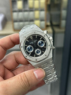 Audemars Piguet watch dial with dark blue chronograph rings and steel bracelet