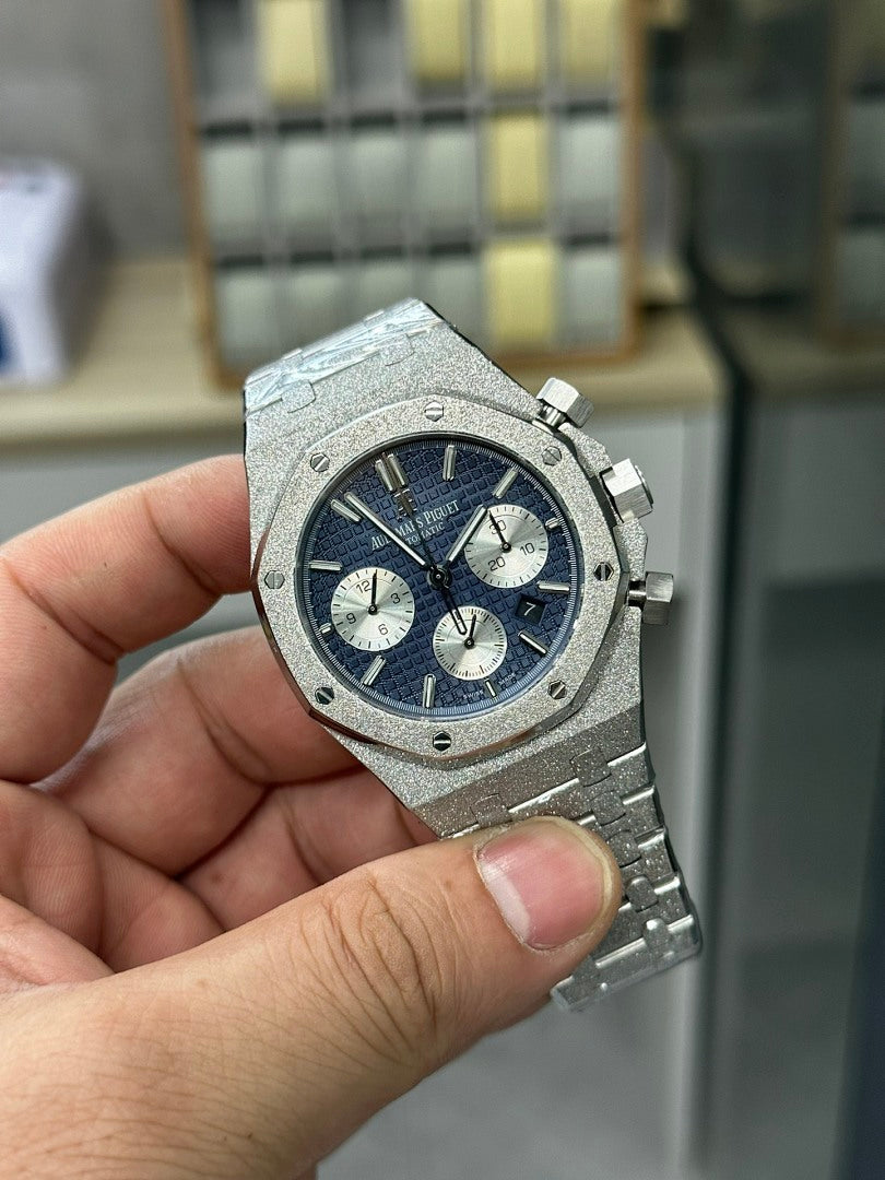 Audemars Piguet watch front with blue dial, chronograph counters, and textured bezel