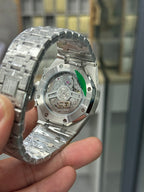 Audemars Piguet watch caseback with visible movement and green accent