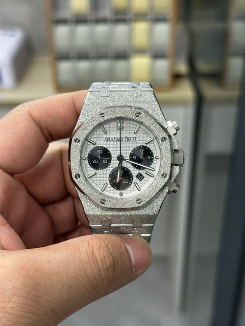 Steel chronograph watch with gray dial, three black subdials, crown and pushers