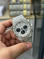 Steel chronograph watch front view with gray dial, black subdials and pushers