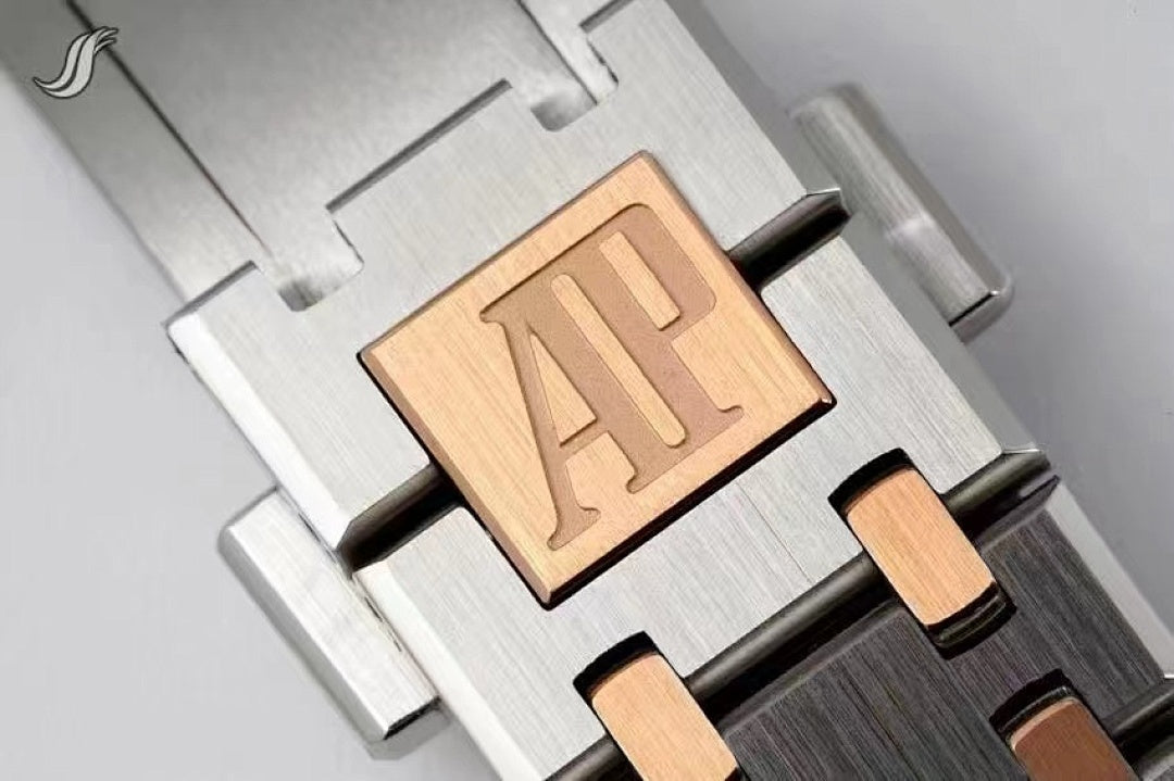 Two-tone bracelet component with engraved AP plaque on metal links.