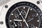 Audemars Piguet chronograph dial close-up with black face, subdials, and tachymeter scale.