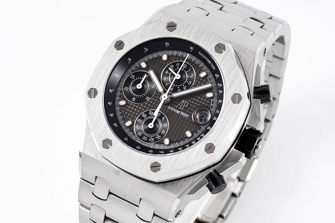 Audemars Piguet luxury chronograph watch with black dial and silver bracelet, angled view.