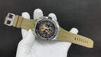 Luxury sports watch on light khaki strap, angled dial and silver case