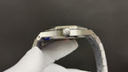 Luxury skeleton wristwatch, silver steel case top view with crown area visible
