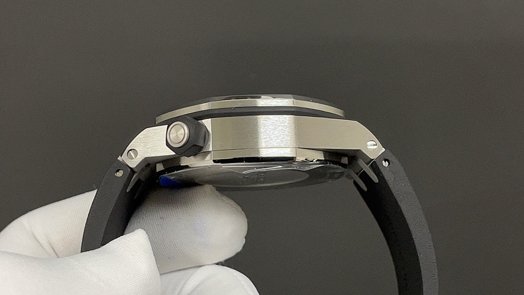 Stainless steel watch case profile with crown guard and curved bezel edge.