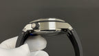 Stainless steel watch case profile with crown guard and curved bezel edge.