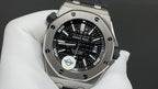 Stainless steel wristwatch with black dial, skeleton-style subdials, and metal bracelet.