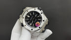 Stainless steel wristwatch with black dial, chronograph-style subdials, and crown.