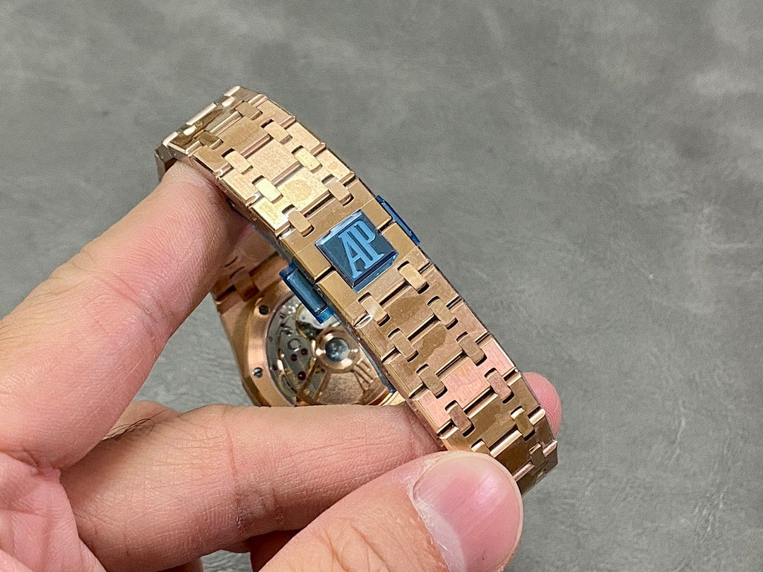 Rose gold watch bracelet detail with clasp and exposed movement through caseback