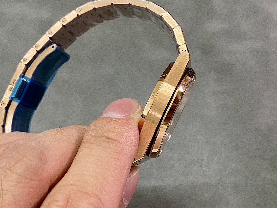 Rose gold watch side profile showing bracelet links and clasp area with blue insert